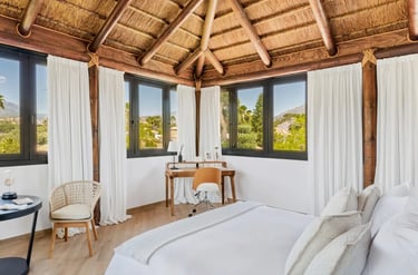 Penthouse suite with thatched ceiling and panoramic mountain views at Villa El Olivo, Marbella