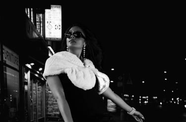 Black and white night street portrait of a woman in an urban setting