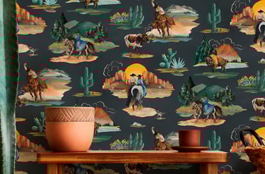 Rustic wooden shelf against western wallpaper featuring cowboys, horses, and desert cactus scenery.