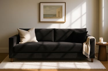 High-end living room featuring a custom black sofa with a long cushion, soft textures.