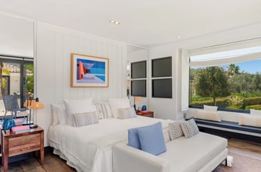 Guest suite with seating nook and garden views at Villa El Olivo, Marbella