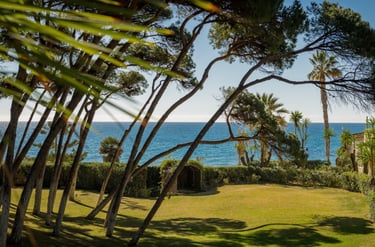 Expansive garden and sea views from the guest house at Villa El Rincon in Marbella.
