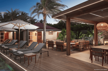 a patio with lounge chairs and umbrellas in st barth
