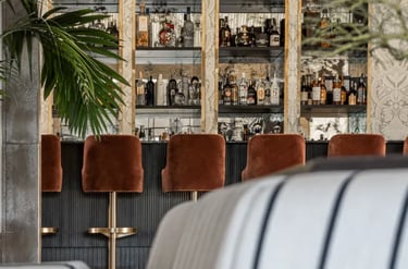 Cocktail bar at Villa La Gratitud with custom cabinetry and velvet seating