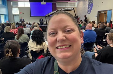 Selfie photo with organization meeting in background