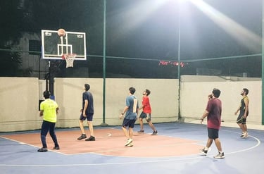 a group of people playing basketball on a court