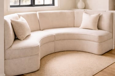 Curved banquette seating in a residential breakfast nook with upholstered custom cushions