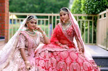 Royal Indian bridal portrait with heavy red pink lehenga, golden dupatta, and regal bridal makeup.