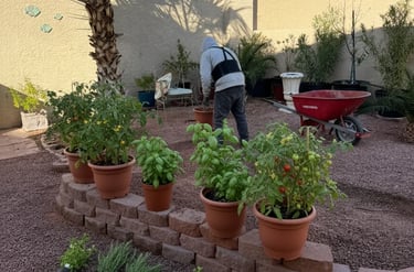 A man working in a backyard garden preparing soil for custom-built raised beds, ideal for growing.
