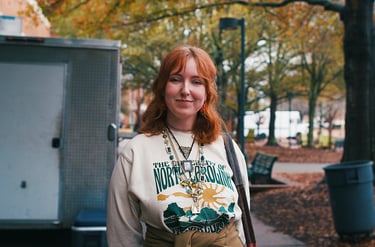 Young redheaded college woman smiling at camera.