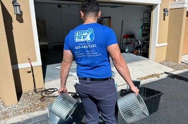 Top Tier Cooling technician carrying blower wheel components for professional HVAC maintenance services.