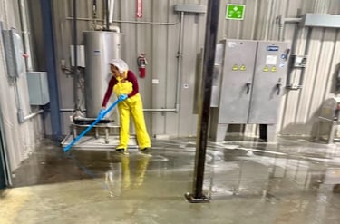 CLEANING SPECIALIST DEEP CLEANS THE FLOOR AT AN INDUSTRIAL FACILITY