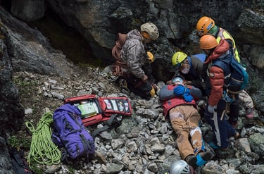 rescuers saving injured on mountain