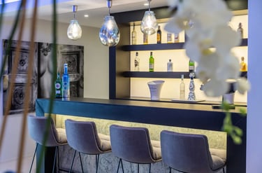 Contemporary home bar with stools at Villa Serenity