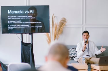 Professional speaker presenting Manusia vs AI lecture with a digital screen and microphone at a seminar.