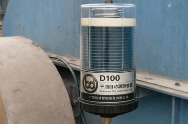 Automatic lubricator mounted on industrial fan bearing for continuous lubrication