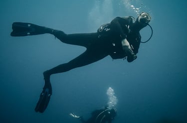 a man and a woman scubas in the ocean