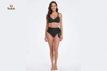 A woman modeling a black two-piece swimsuit with high-waisted bikini bottoms and an underwire top.