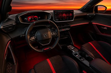 Interior do Peugeot E-208 GTi com painel digital, iluminação vermelha e acabamento esportivo