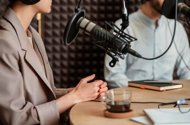 Close-up of microphone and host’s hands during a podcast recording at Miami Creator Studio.