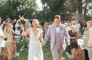 ortie de cérémonie laïque avec lancer de pétales pour un couple de mariés heureux.