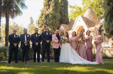 Visalia wedding photographer capturing a bridal party in pink and navy at an outdoor venue.