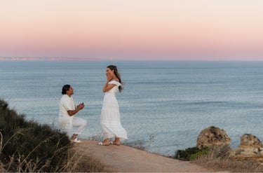 a man proposing a woman on a cliff overlooking the ocean