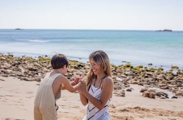 a boy and girl playing with a kite