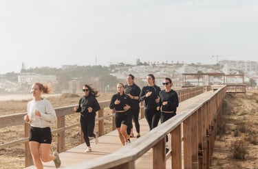 a group of people running on a boardwalk