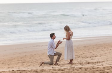 a man kneeling down to a woman who is kneeling down