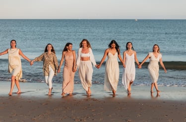 a group of women in white dresses holding hands and holding hands