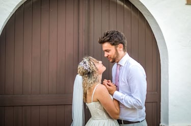 a bride and groom standing in front of a wooden door