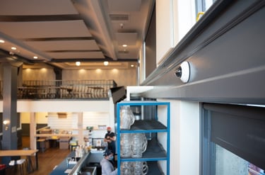 Cloud-Based Surveillance Camera Installed on Wall in Restaurant