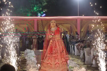 A happy Indian bride in a red lehenga with professional bridal makeup by R&D Bridal Makeup in Vadoda