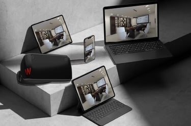 Modern devices including a laptop, tablet, smartphone, and VR headset arranged on a geometric surfac