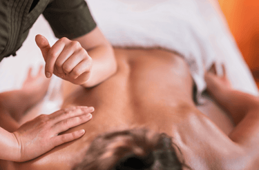 A woman getting a sports massage for her lower back.
