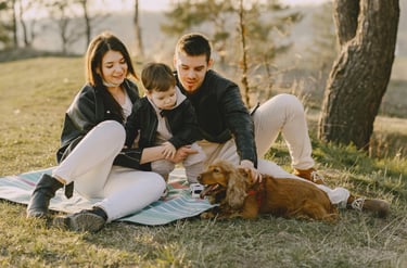 Young family sitting with their dog