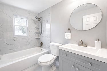 Modern bathroom renovation in Woodbridge, VA featuring upgraded tile, new fixtures, and a clean, ref