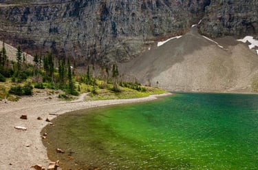 Emerald water at Crypt Lake surrounded by towering cliffs in Waterton Lakes National Park
