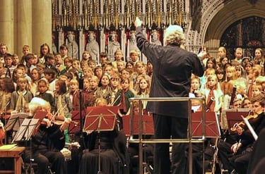 Conductor Simon Wright leads a children's choir and live orchestra during a concert at York Minster