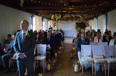 Groom waiting for his bride to walk up the aisle
