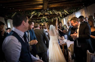 bride and groom entering their evening celebrations at Tudor Barn Eltham