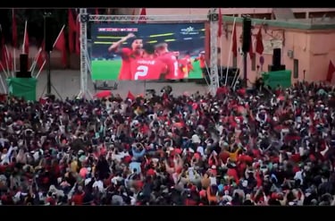 a large screen tv screen with a man in a red shirt