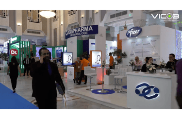 a man in a suit and tie dyes a tie on a white counter