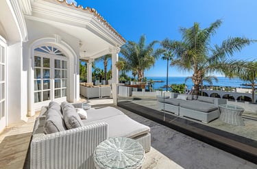 Covered terrace with seating in upscale villa by the sea Marbella