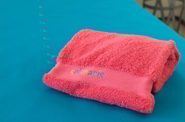 a towel towel on a table with a pink towel