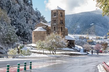 The Romanesque Sant Joan de Caselles church in Andorra covered in fresh winter snow.