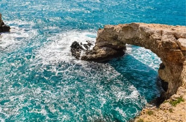 Natural stone bridge arch over turquoise Mediterranean sea water in Ayia Napa, Cyprus.