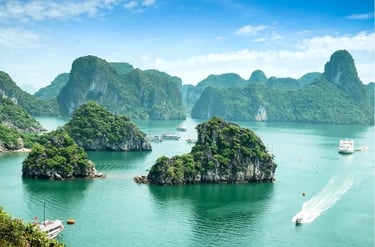 Scenic view of Ha Long Bay in Vietnam featuring lush limestone karsts, emerald waters, and cruise boats.