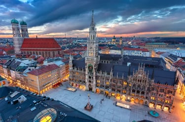 Panoramic sunset view of Marienplatz with the New Town Hall and Frauenkirche in Munich, Germany.